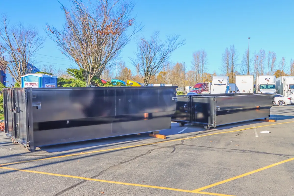 Professional dumpster rental service with roll-off container on residential driveway in Mansfield